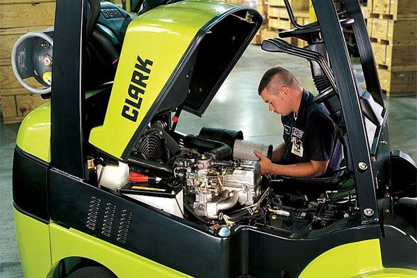 Orange and black forklift parked outside, ACE logo visible.