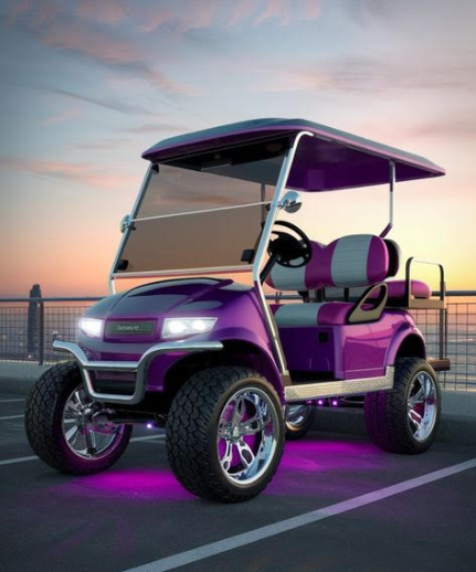Orange forklift arm with forks against a bright blue sky.