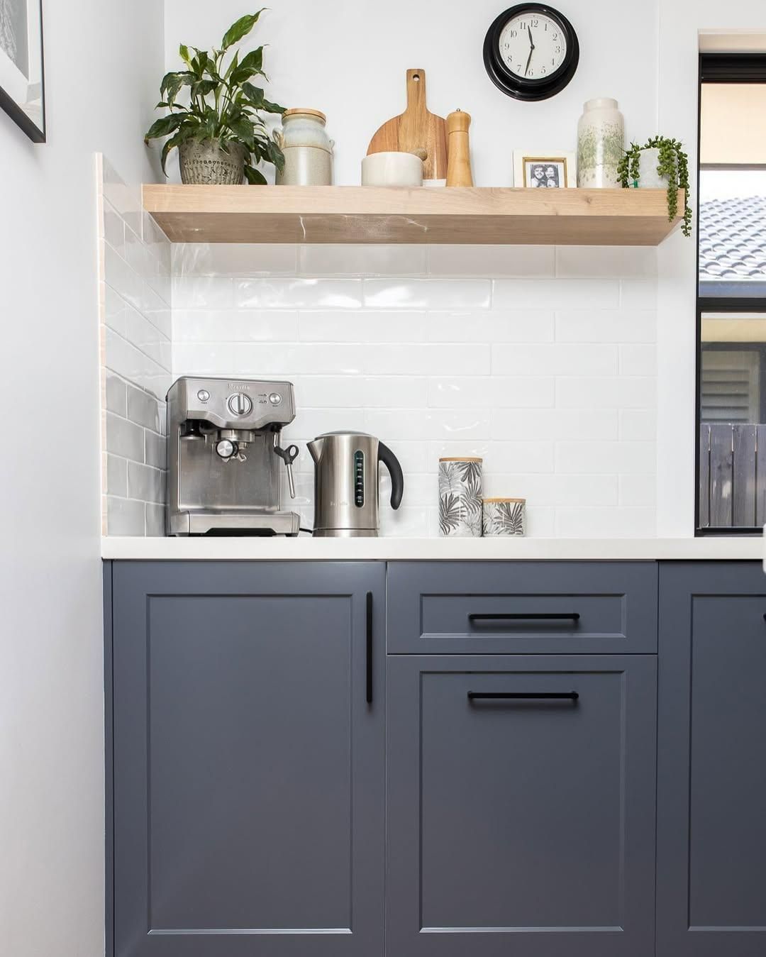 A Kitchen with Blue Cabinets and A Coffee Maker on The Counter — Caldera Kitchens and Bathrooms in Lynchs Creek, NSW