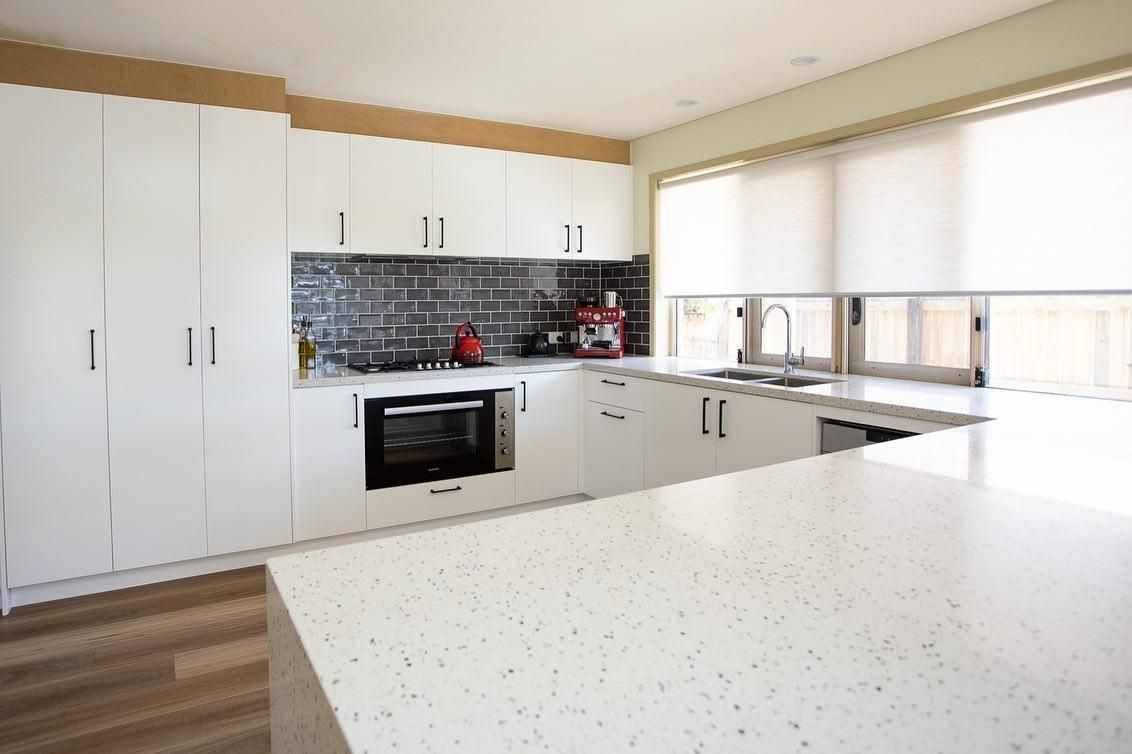 A Kitchen with White Cabinets and A White Counter Top — Caldera Kitchens and Bathrooms in Lynchs Creek, NSW