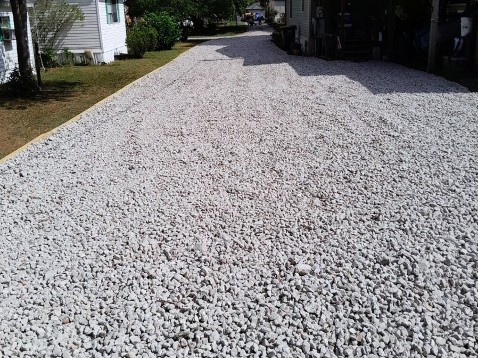 A freshly installed gravel driveway covered with clean, light-colored crushed stone in Port St. Lucie.