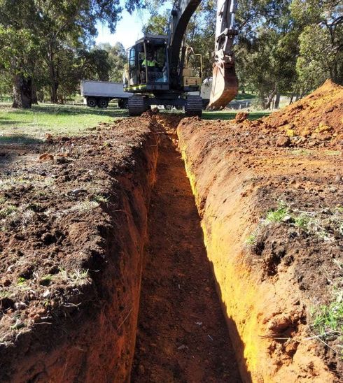 An excavator is digging a trench.