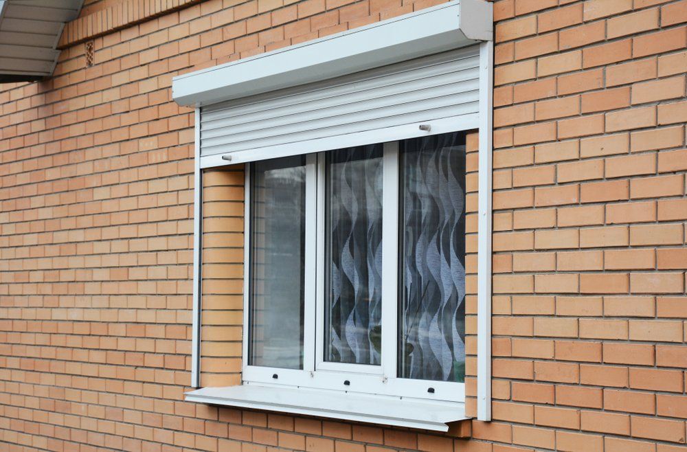 Roller Shutters Brick House Window Protection — Custom Window Furnishings in Wagga Wagga, NSW