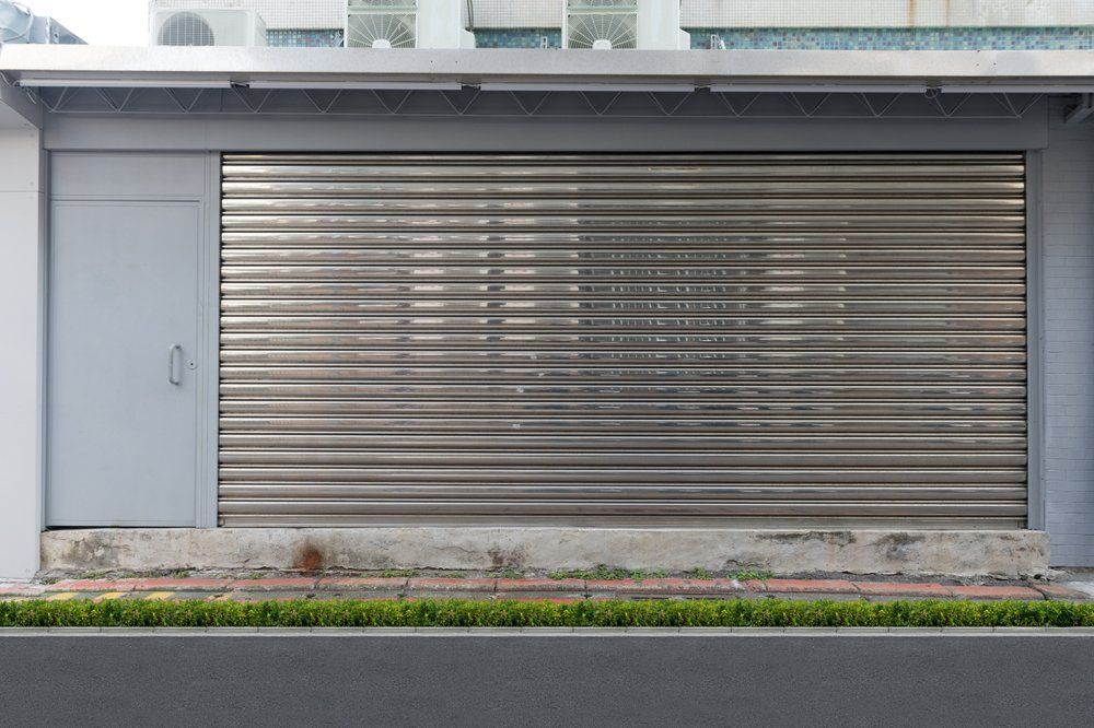 A Close Up Shot of Automatic Metal Roller Door Used in Factory — Custom Window Furnishings in Wagga Wagga, NSW