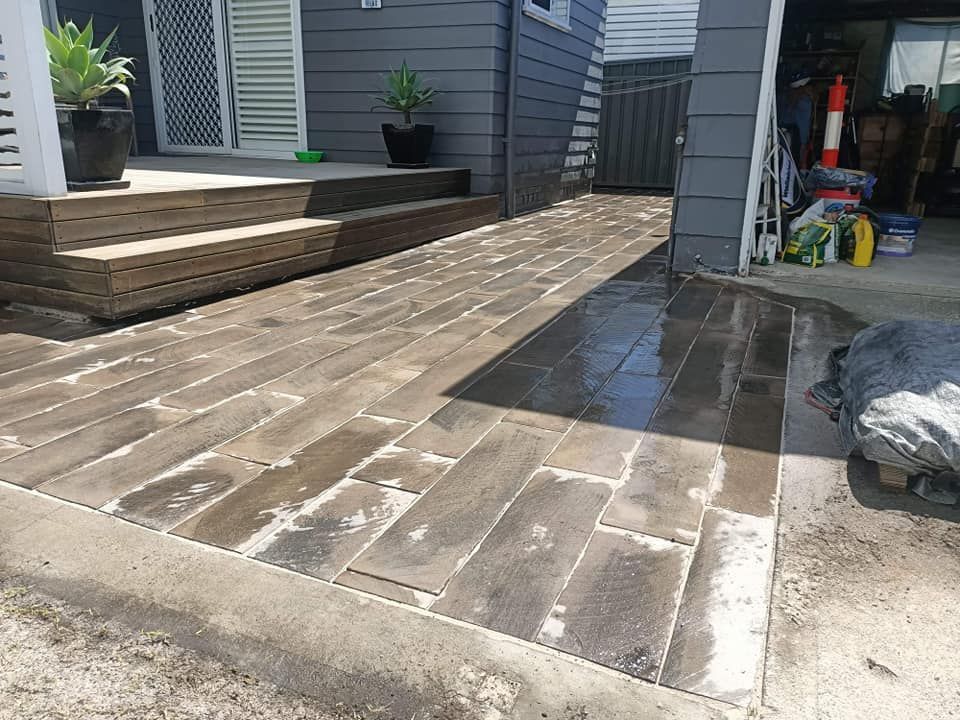 A wooden walkway is being built in front of a house.