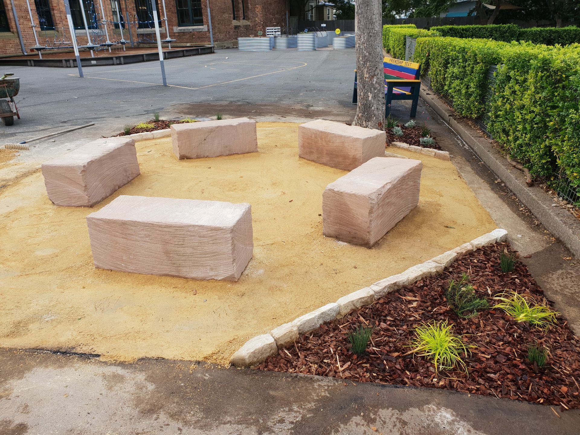 A group of bricks are sitting in a circle in the dirt.