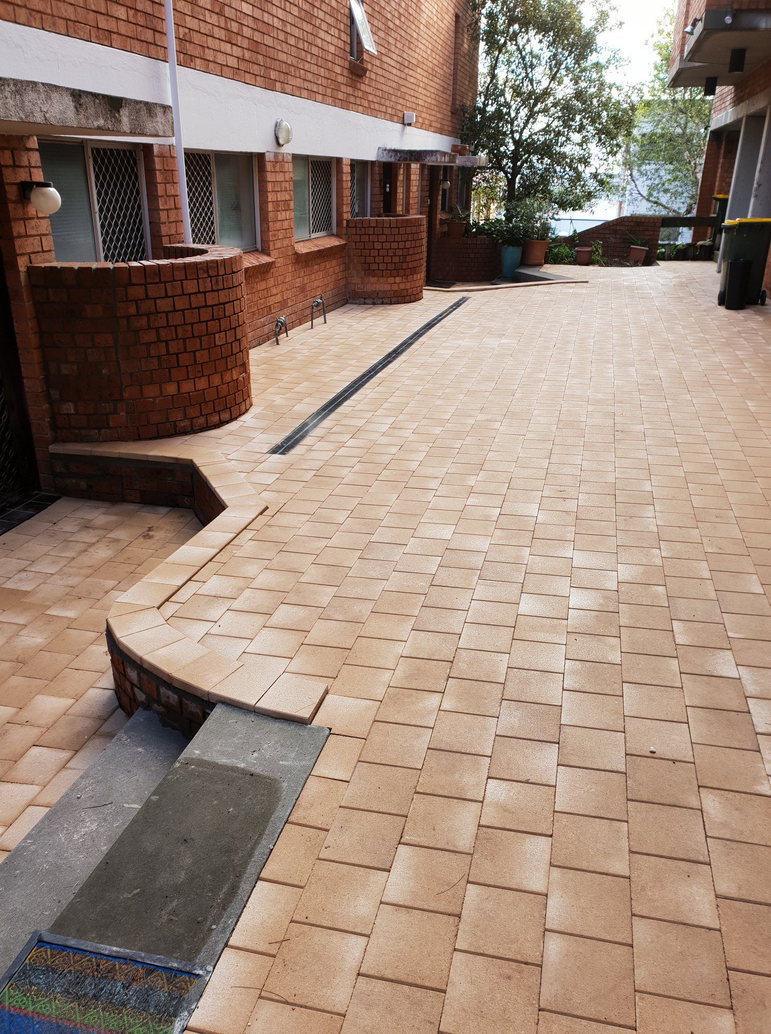 A brick walkway in front of a brick building