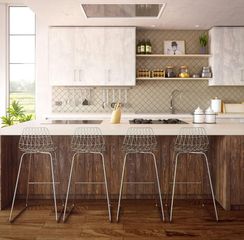 A modern kitchen with white upper cabinets, dark wood base cabinets, an island with four clear stools, and tile backsplash.