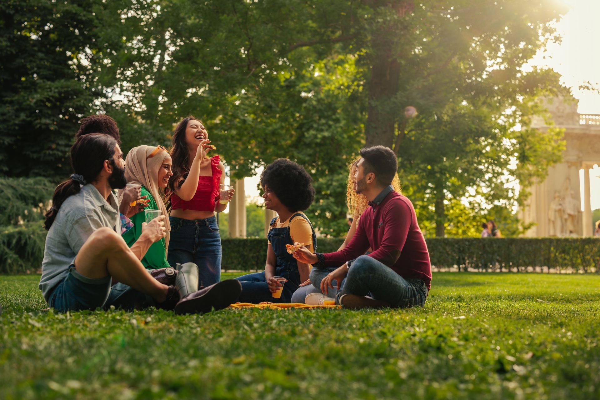 A group of friends enjoying a picnic on a sunny day in a park.