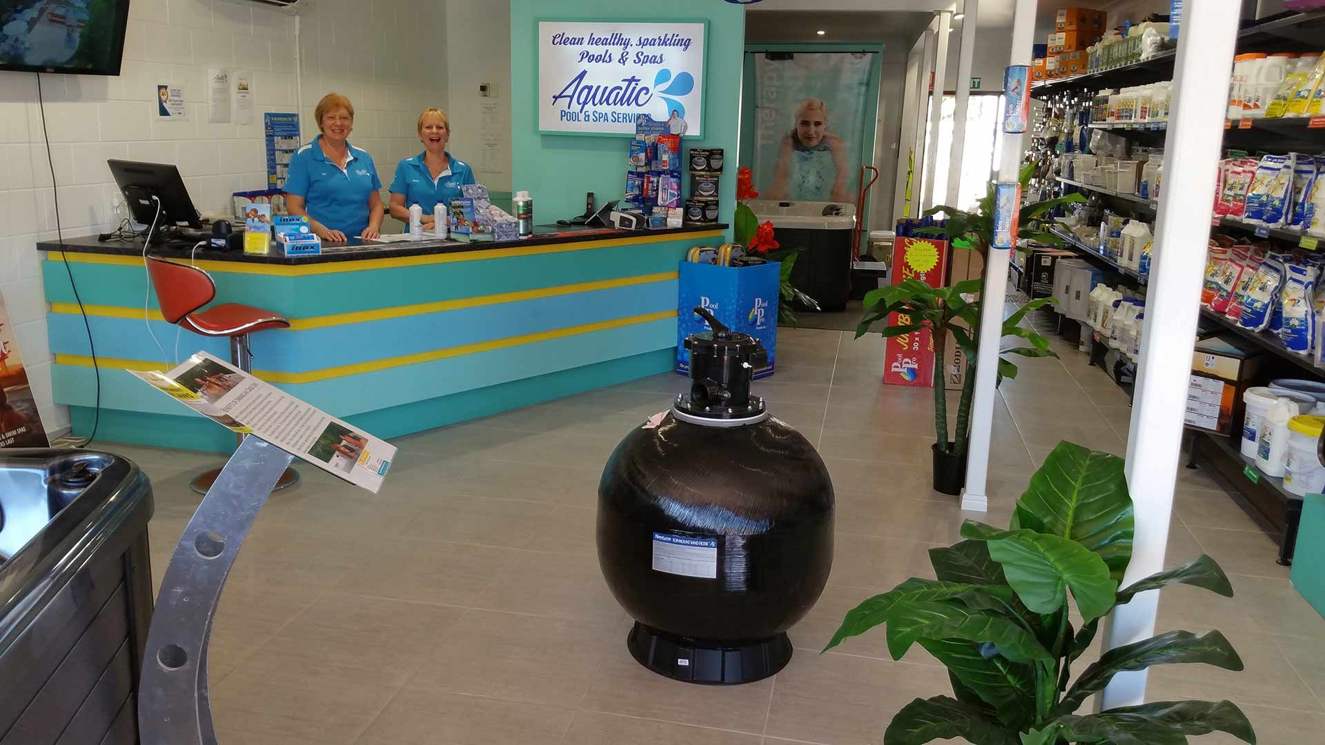 Two Women Are Standing At A Counter In A Store — Aquatic Pool & Spa Services In Yeppoon, QLD