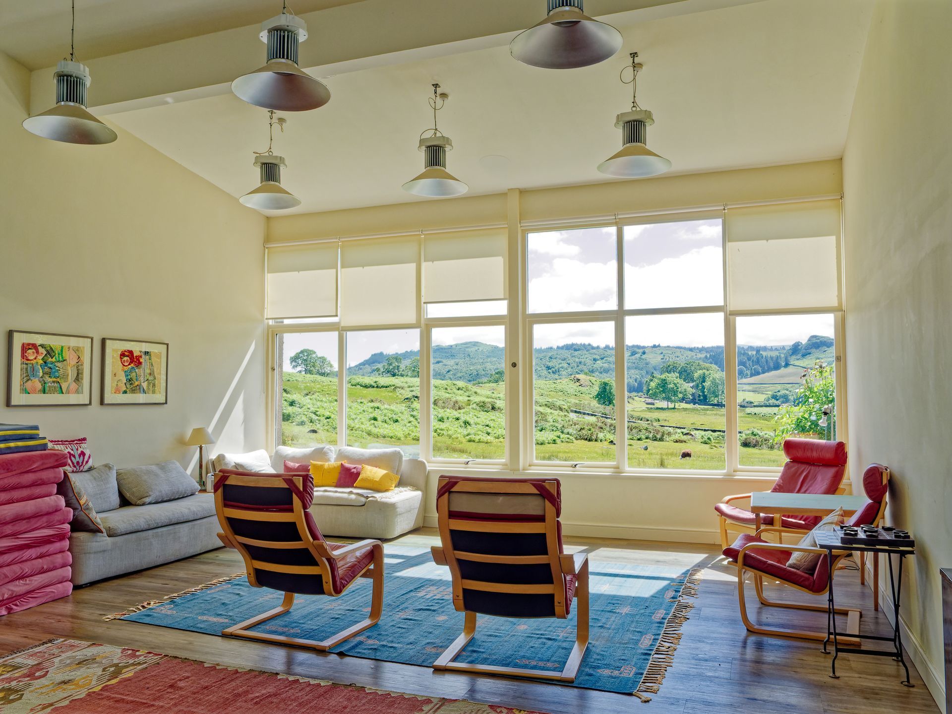 A living room with a lot of windows and chairs