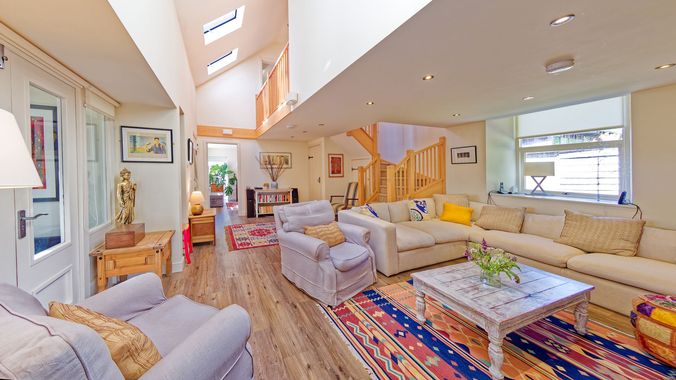 A living room with a couch , chairs , and a coffee table.