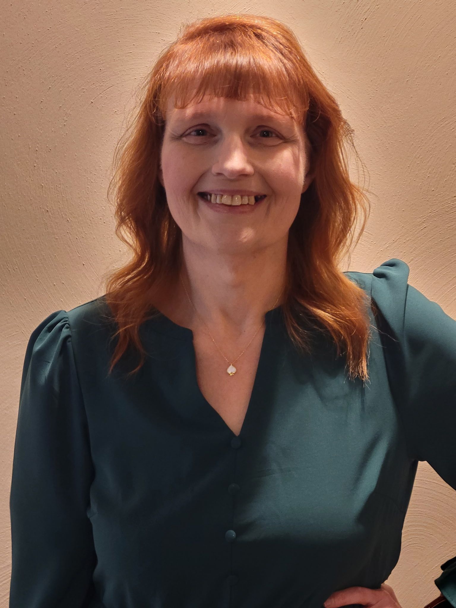 a woman wearing a printed top.