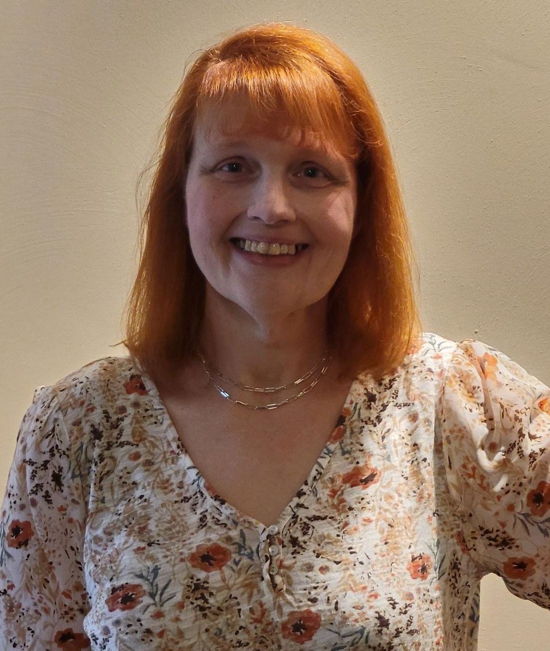 a woman wearing a printed top.