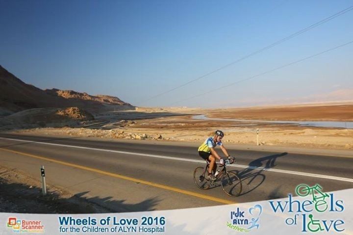 A men riding a bicycle part of the wheels of love 2016 hospital