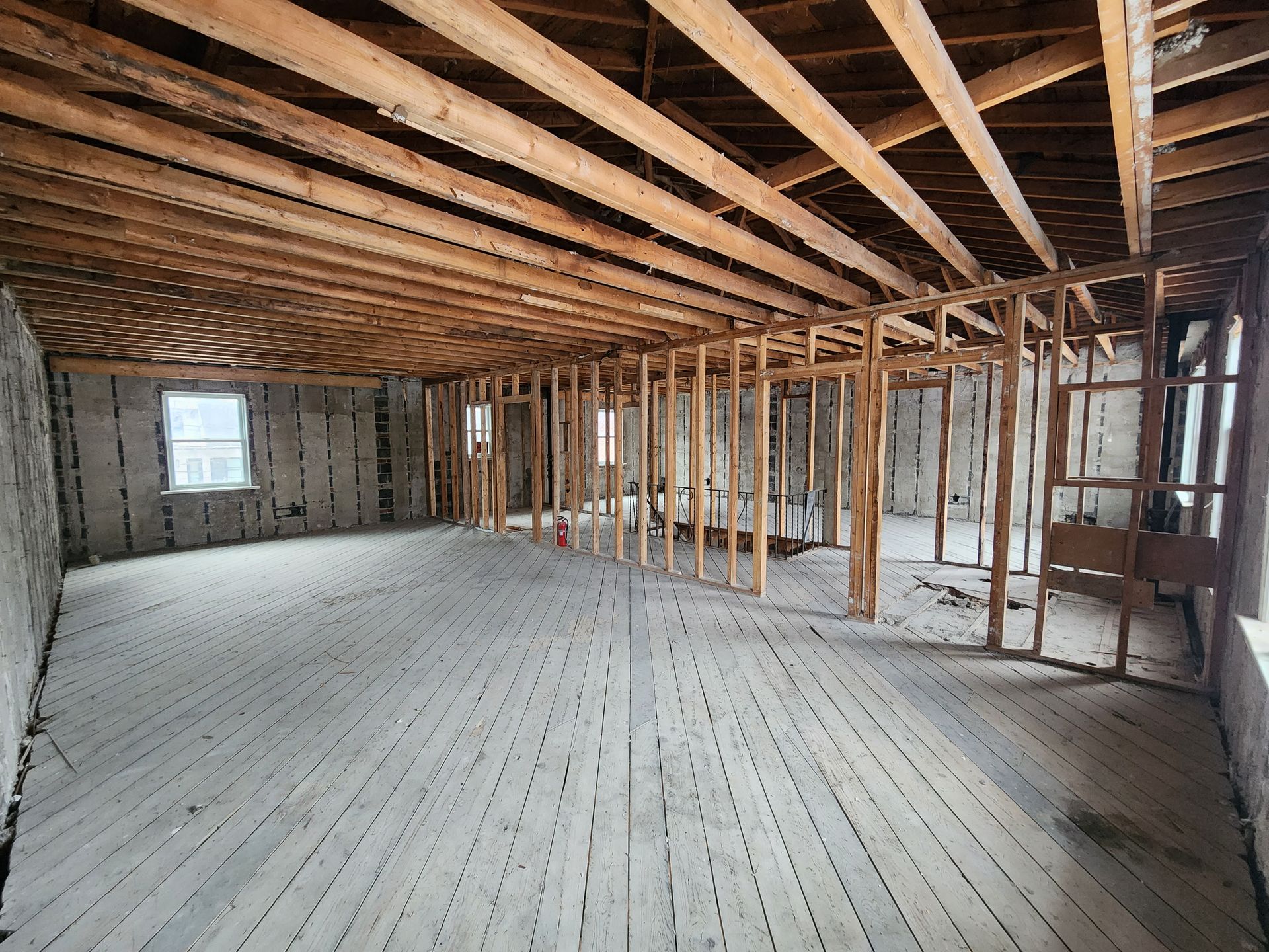 An empty room with a wooden floor and ceiling.