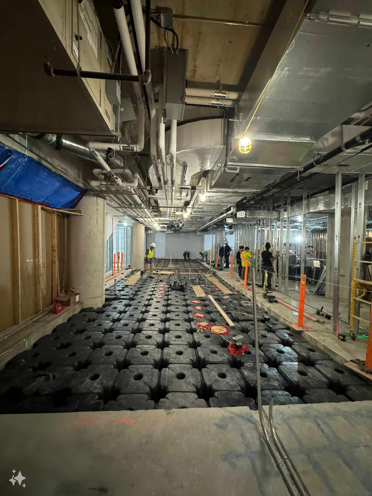 A large room with a lot of holes in the floor is being built.