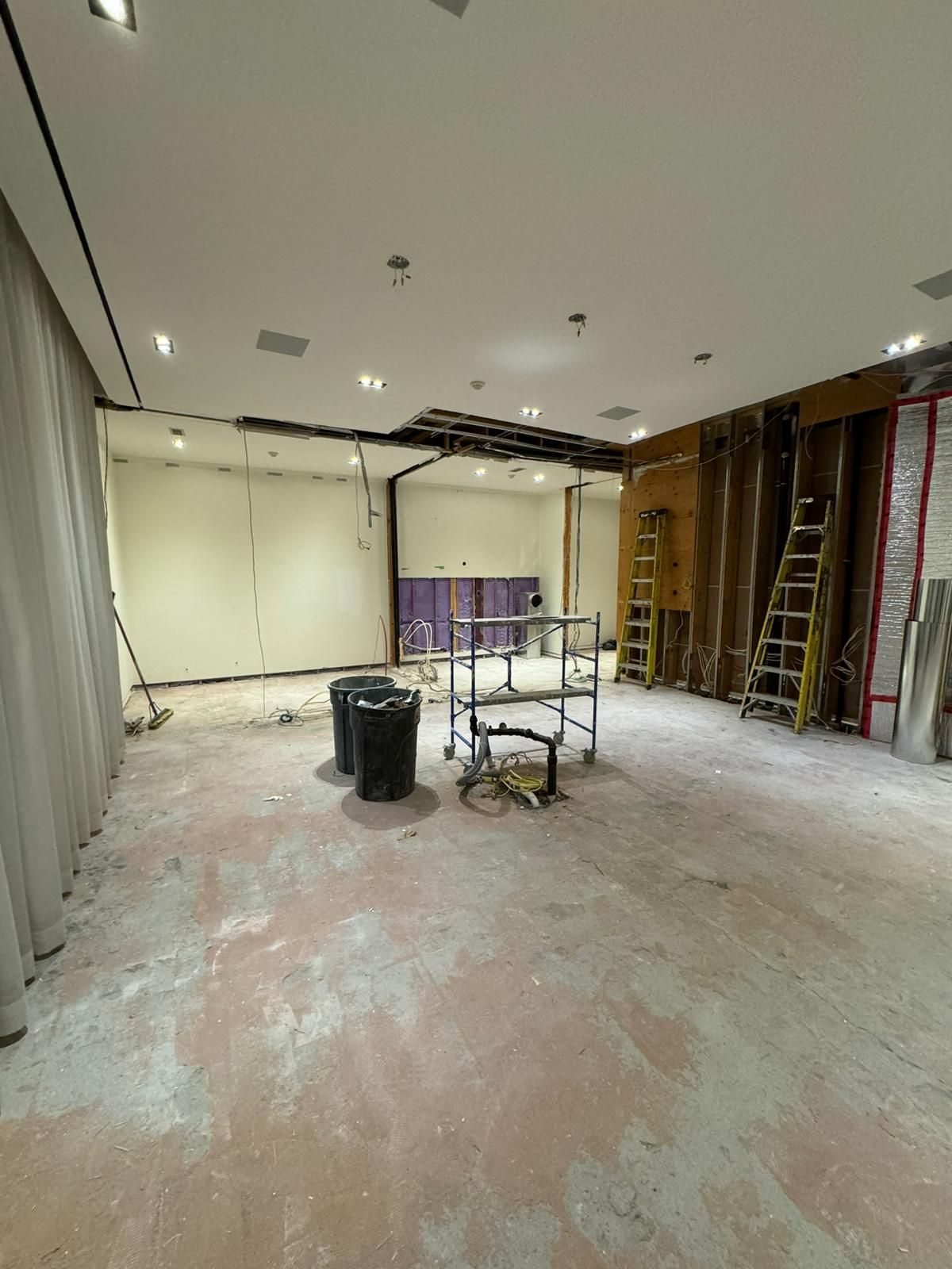 A large empty room with a lot of scaffolding in it.