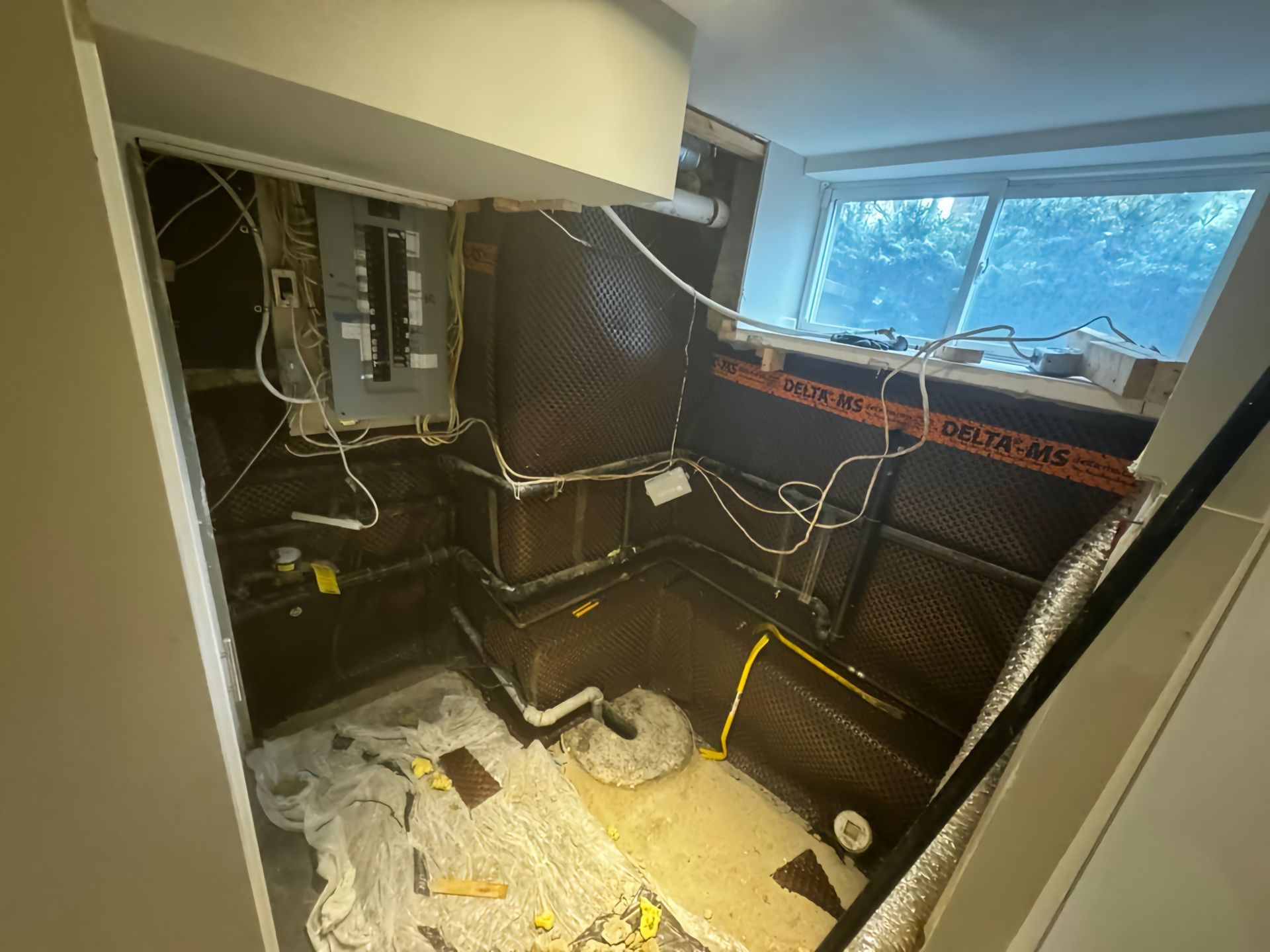 A room with a lot of wires coming out of it and a window.