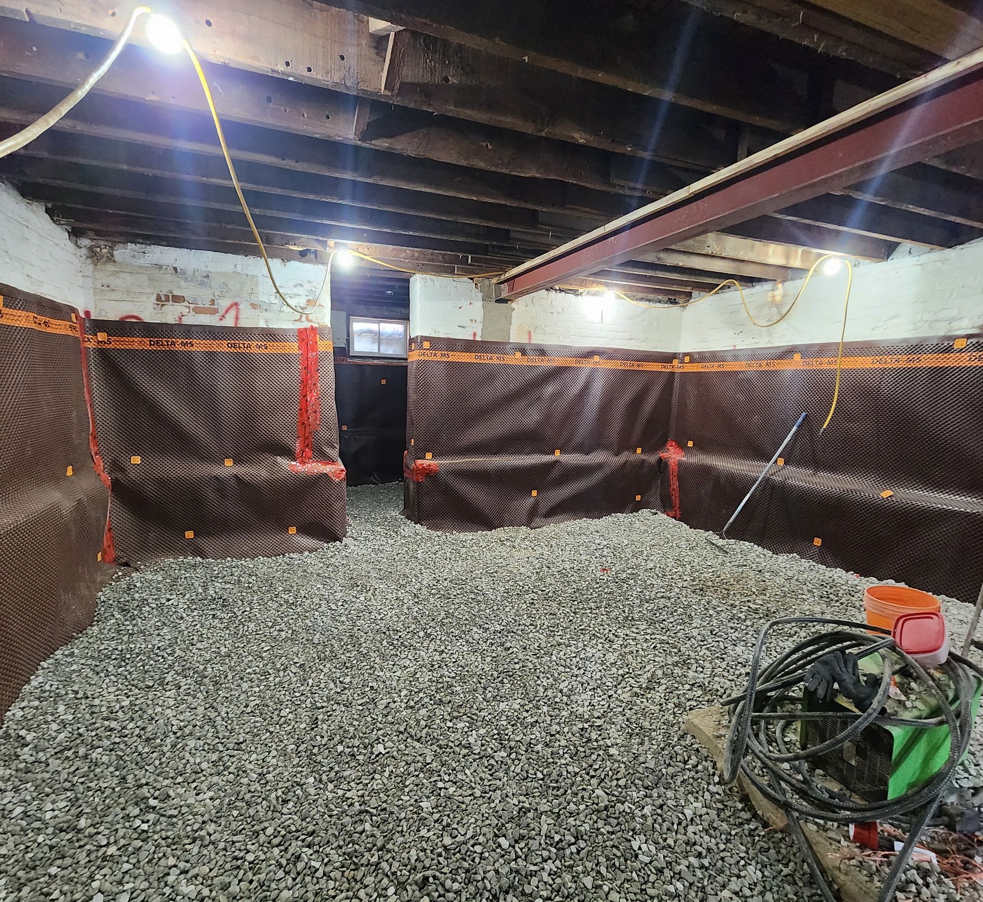 A basement with a lot of gravel in it.