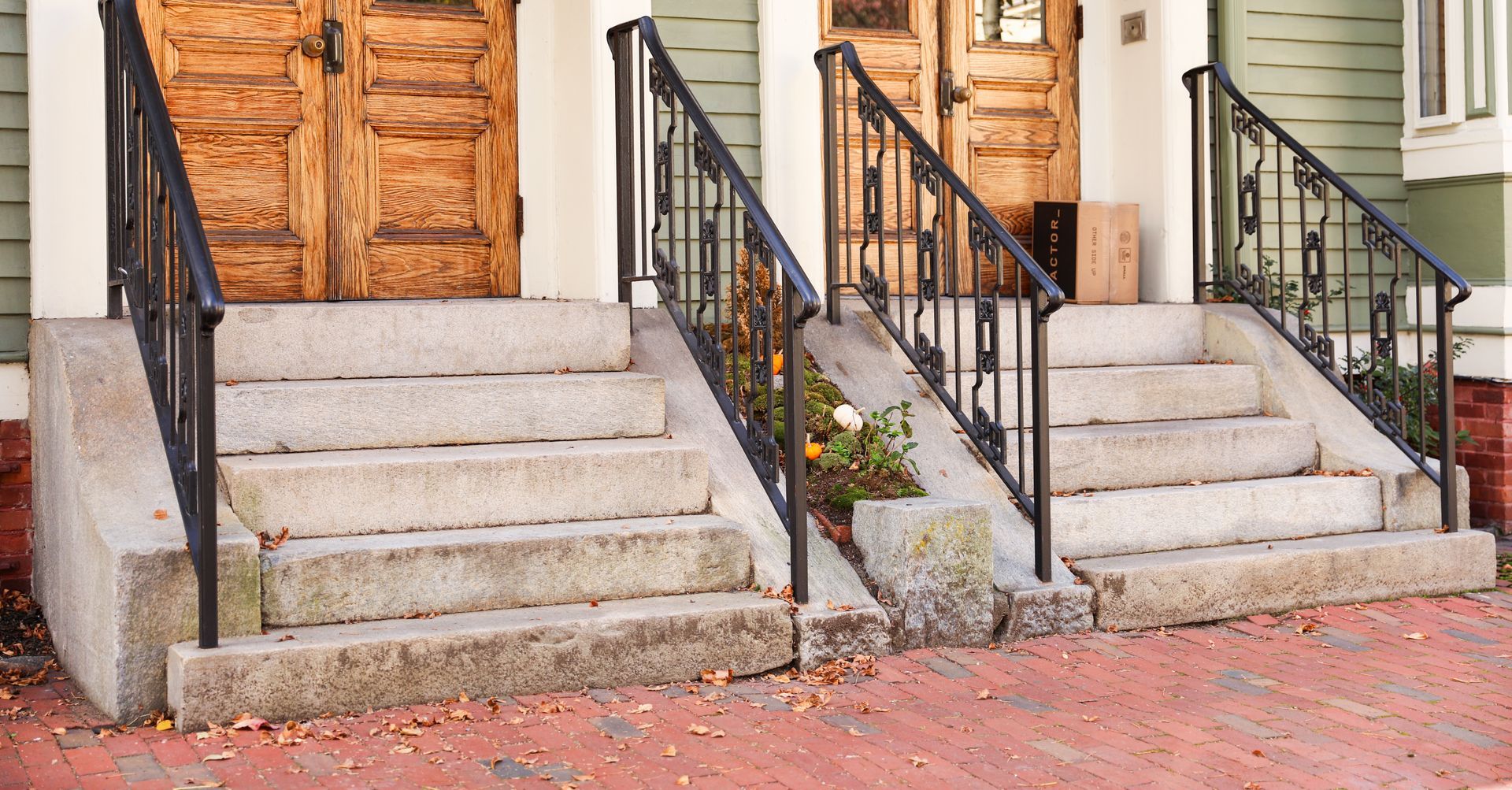 A row of stairs leading up to a house with wooden doors