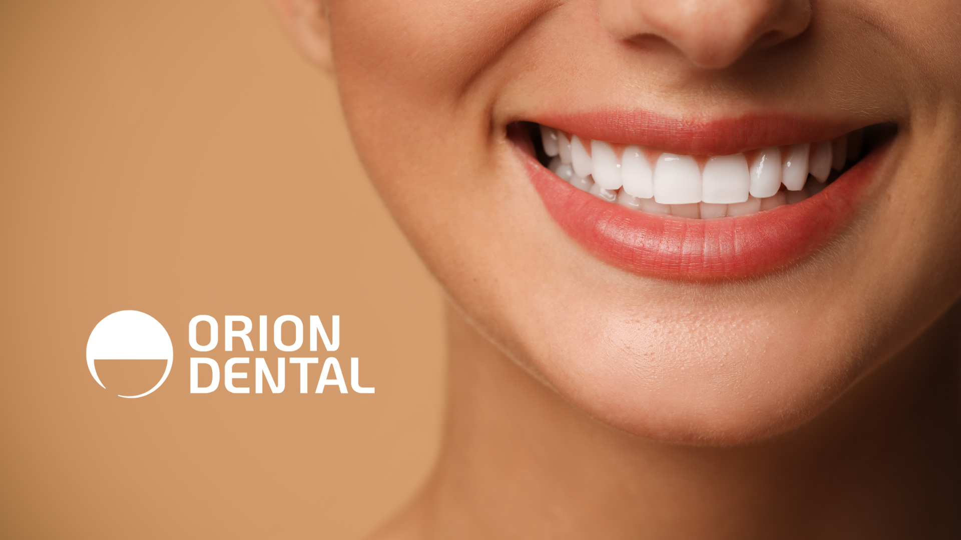A close up of a woman 's smile with a logo in the background.