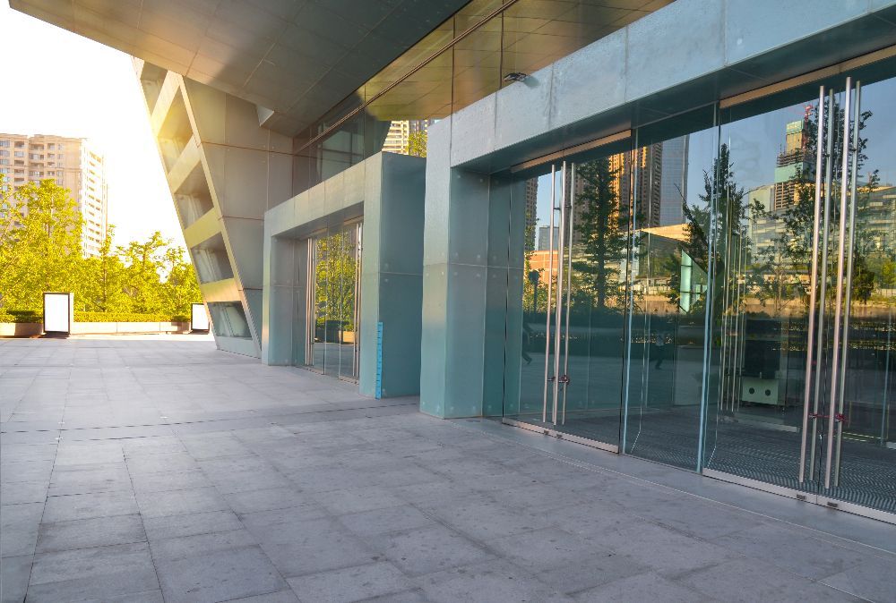 There is a large building with a lot of glass doors.