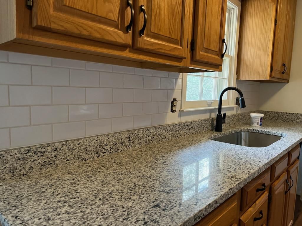 A kitchen with granite counter tops and a sink.