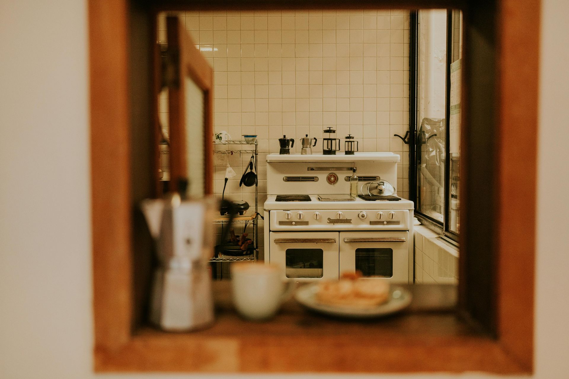 A kitchen with a stove and a plate of food on the counter.