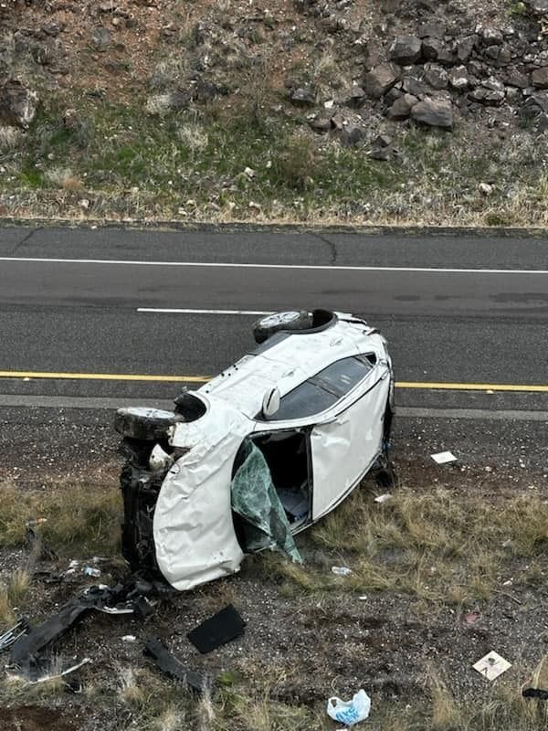 An SUV lies on its side after a crash on I-17
