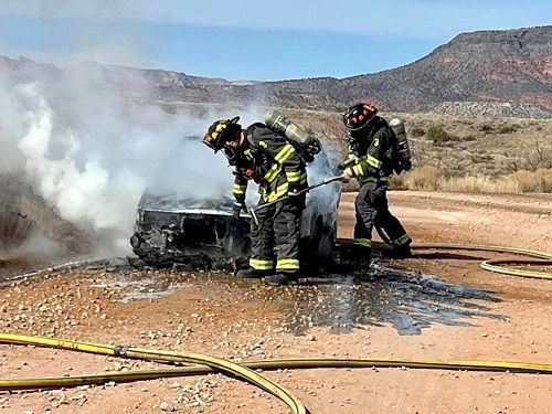 Two Verde Valley Fire District firefighters battle a car fire