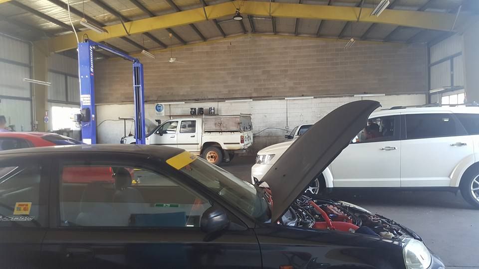 A Black Car With Its Hood Up in a Garage — JDM Mechanical & Aircon Repairs In Coconut Grove, NT