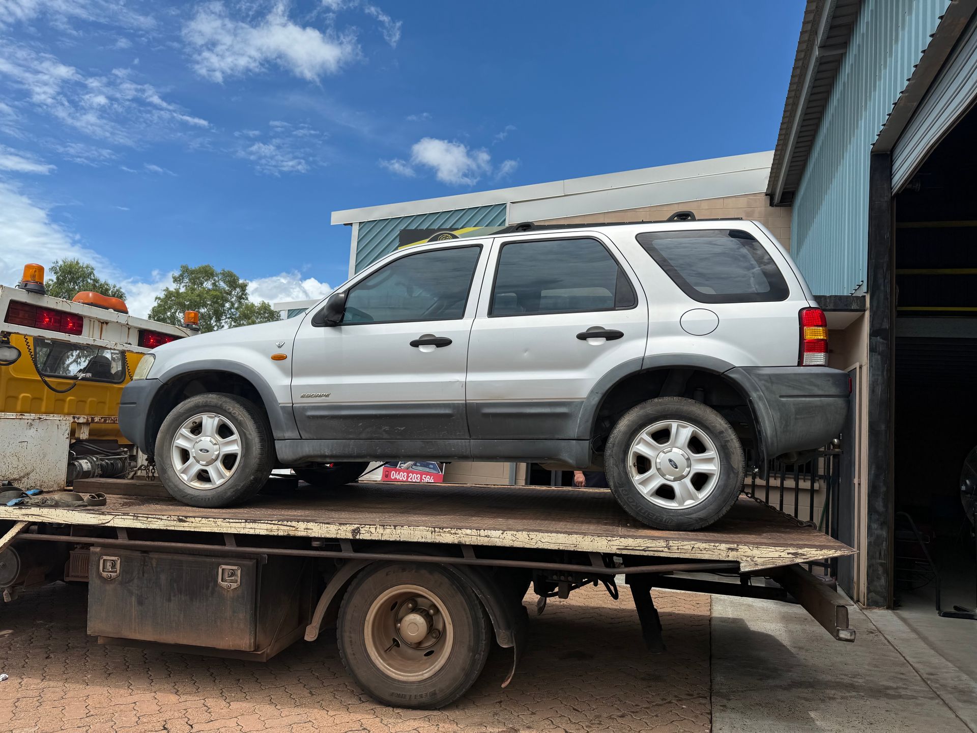 A Car Is Being Towed — JDM Mechanical & Aircon Repairs In Coconut Grove, NT