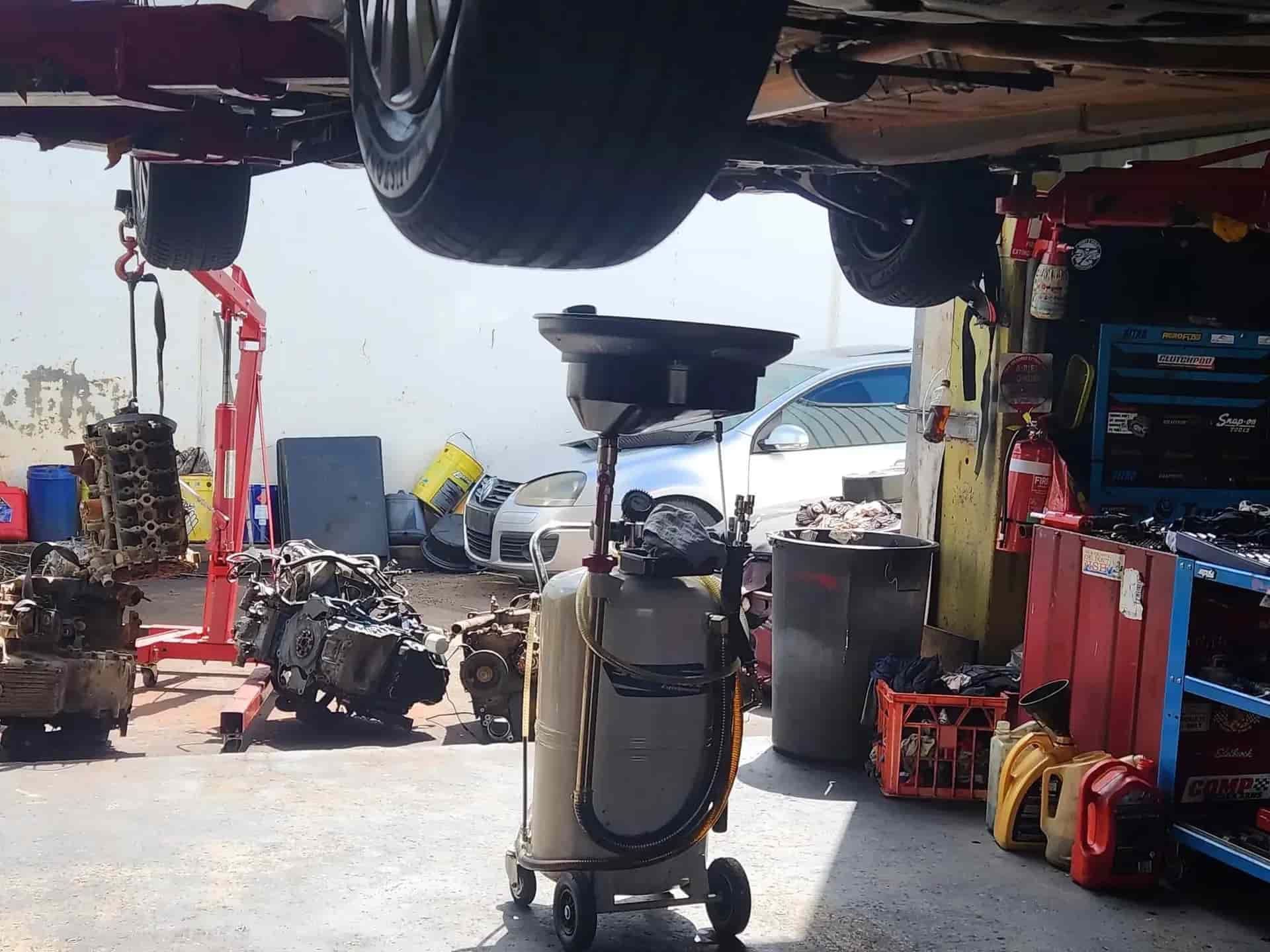 A Car is Being Worked on in a Garage With a Vacuum Cleaner — JDM Mechanical & Aircon Repairs In Coconut Grove, NT
