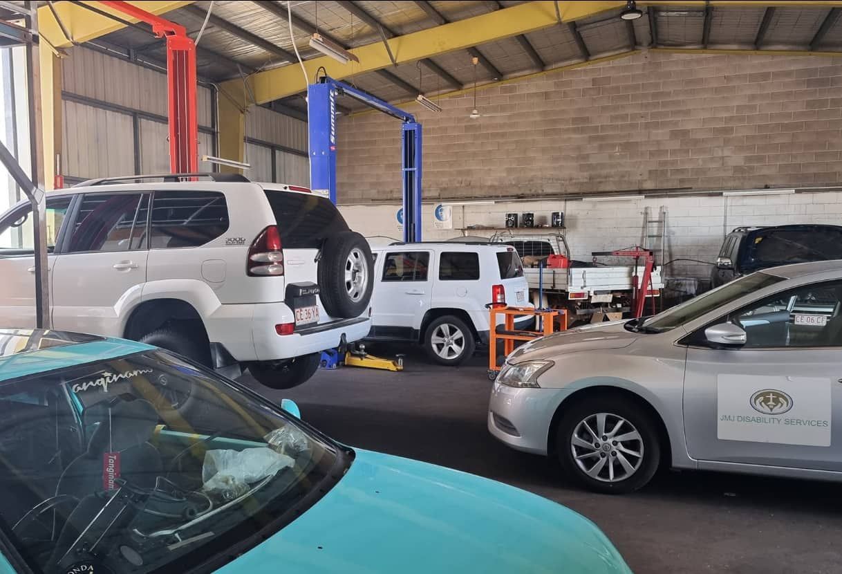 A Row of Cars Are Parked in a Garage — JDM Mechanical & Aircon Repairs In Coconut Grove, NT