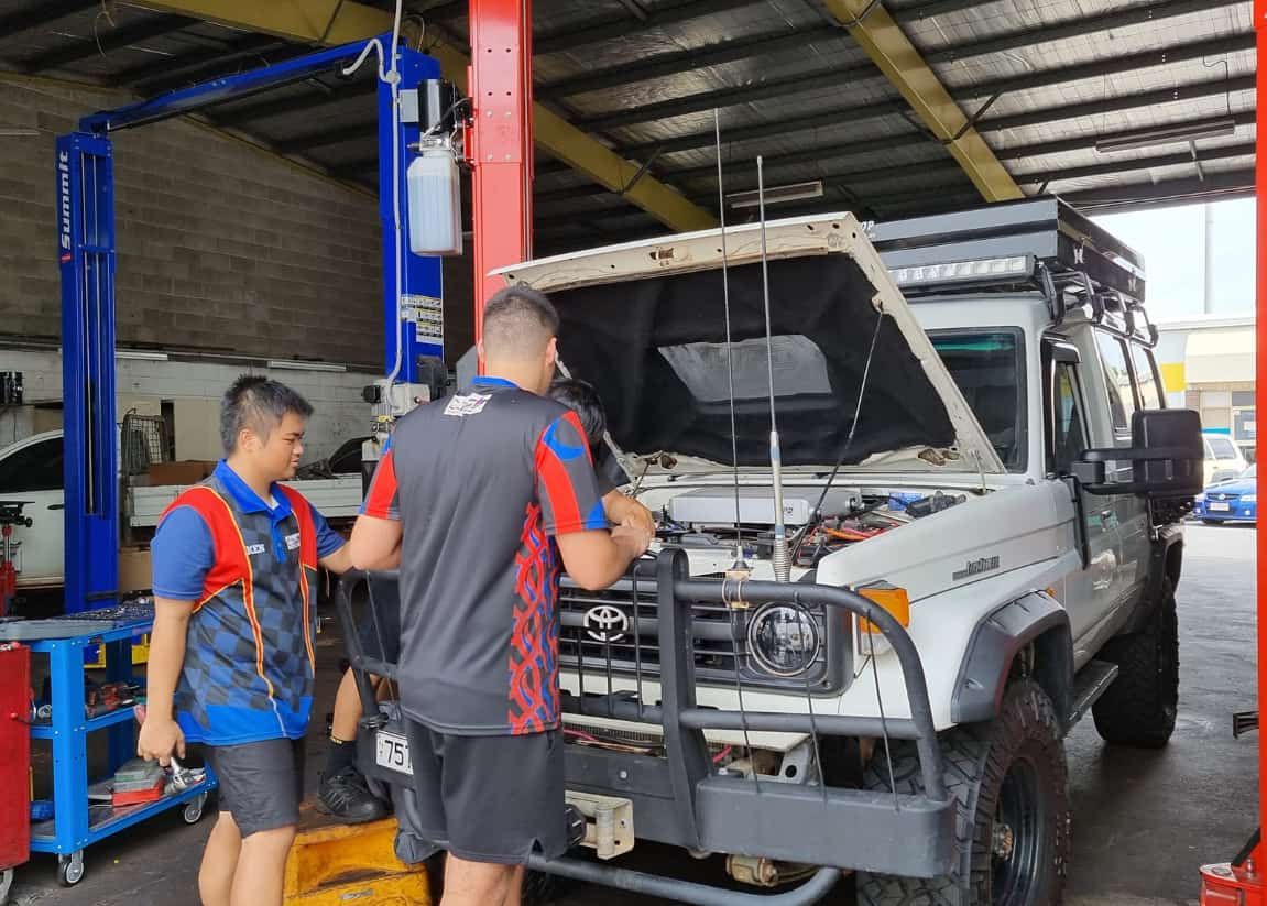 Two Men Are Working on a Truck in a Garage — JDM Mechanical & Aircon Repairs In Coconut Grove, NT