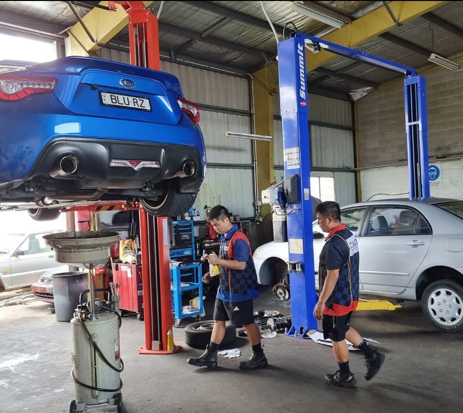 A Blue Car on a Lift — JDM Mechanical & Aircon Repairs In Coconut Grove, NT