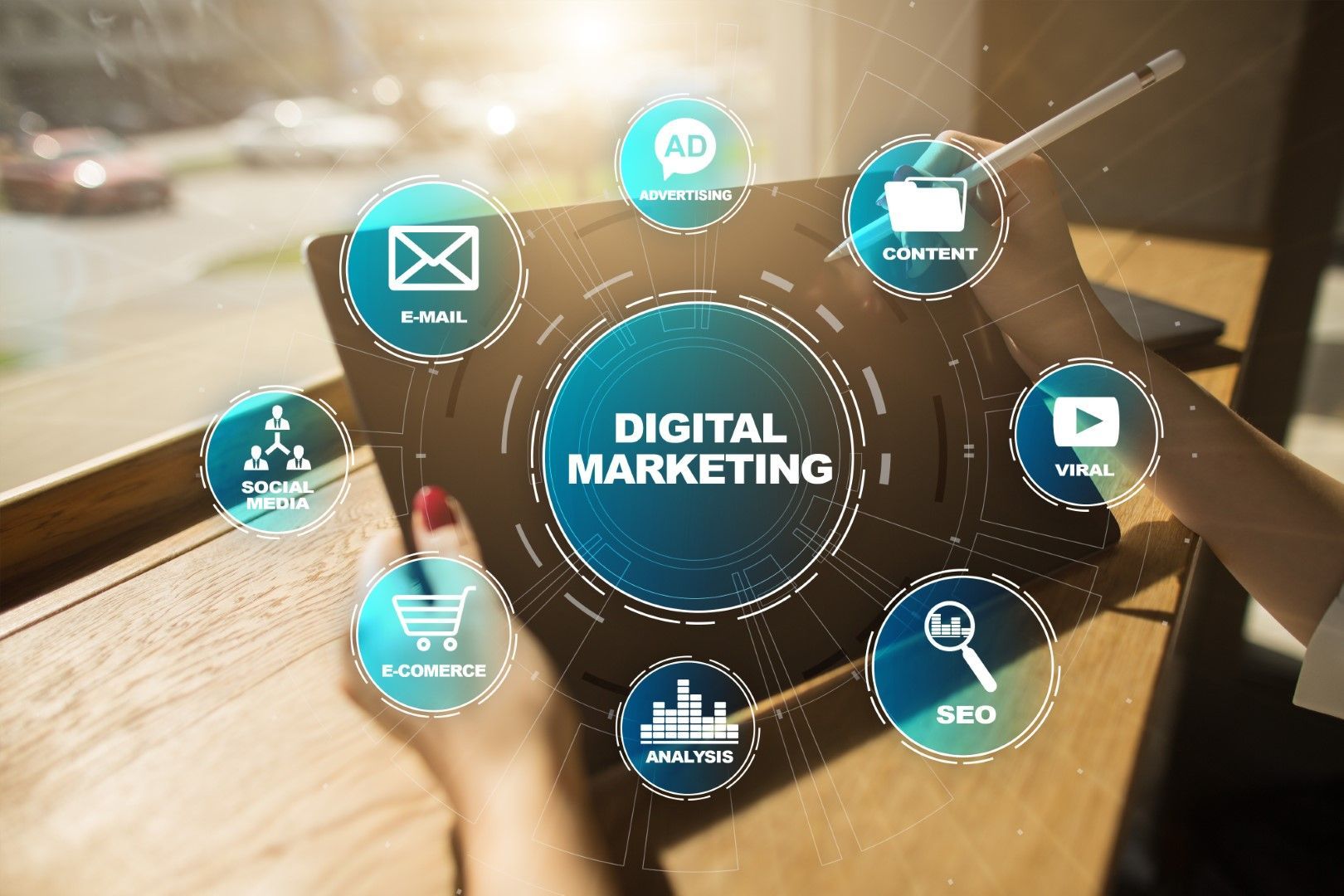 Person using tablet with digital marketing icons overlayed.