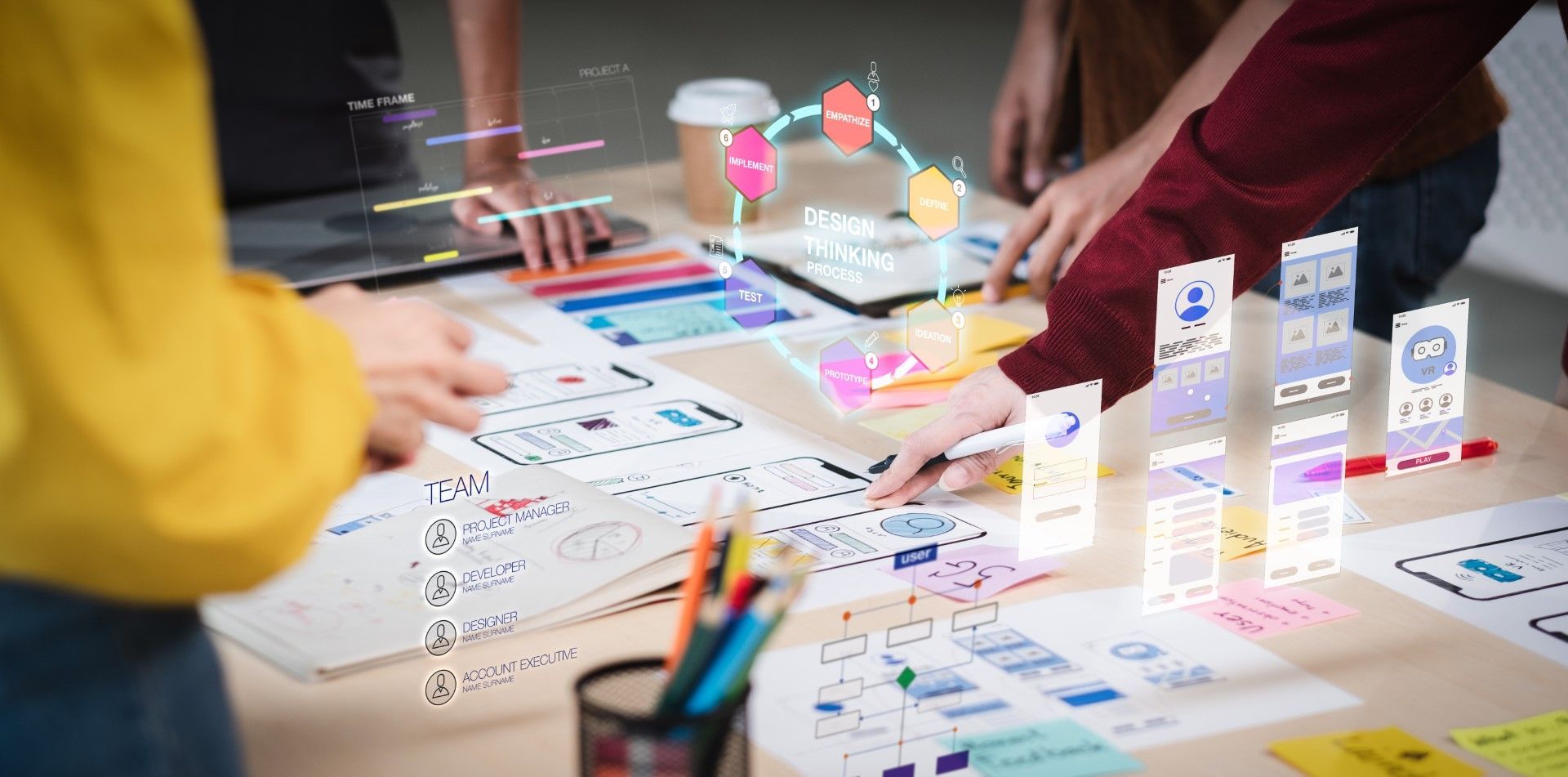 Team collaborates on design project with sketches, colorful graphics, and augmented reality elements.