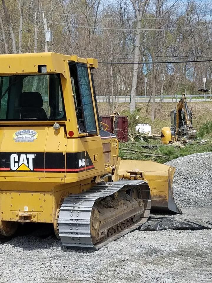 Yellow Caterpillar bulldozer on gravel, construction site.