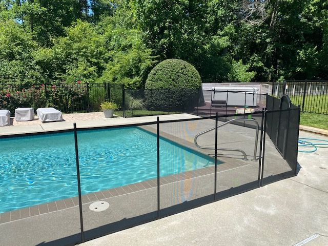 A large swimming pool with a fence around it.