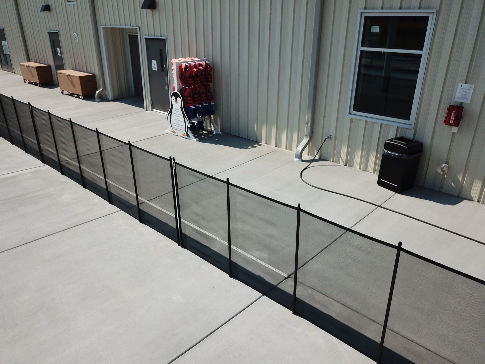 An aerial view of a fence along the side of a building.