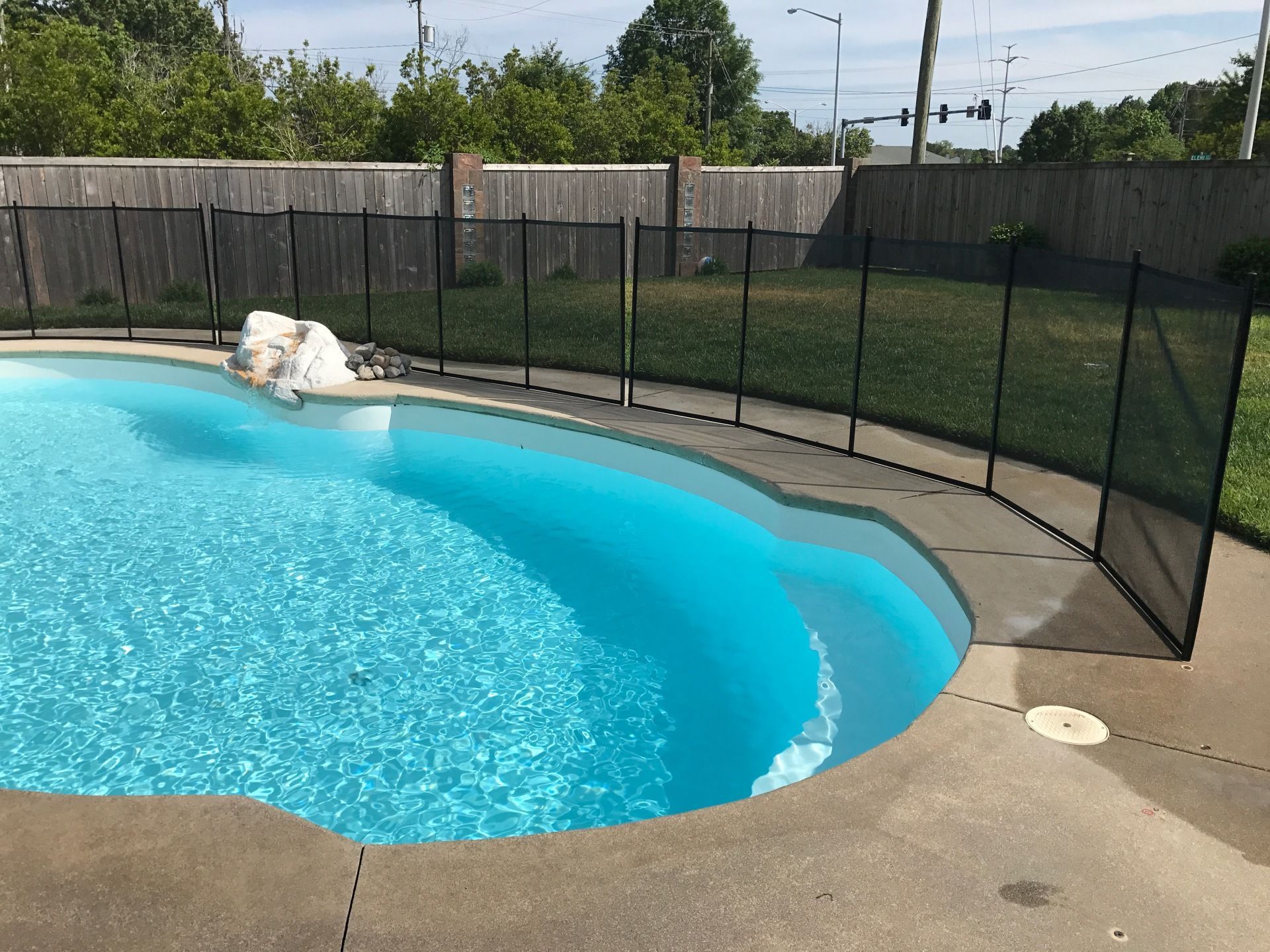 A large swimming pool with a fence around it