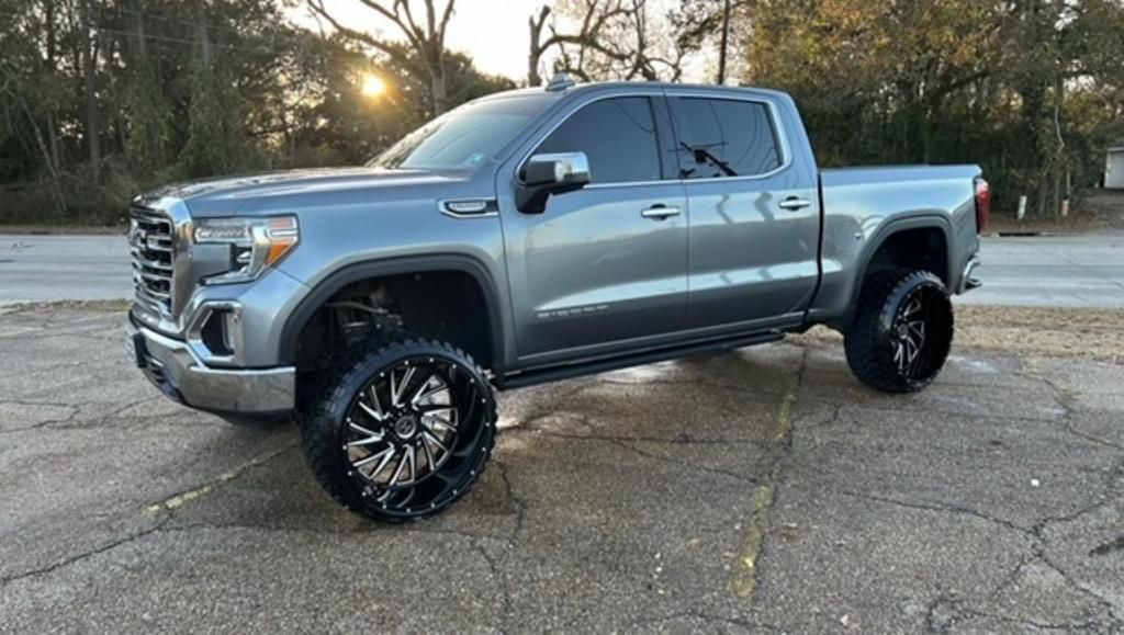 A gray pickup truck is parked on the side of the road.
