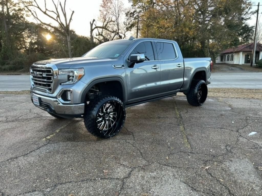 A gray pickup truck is parked on the side of the road.