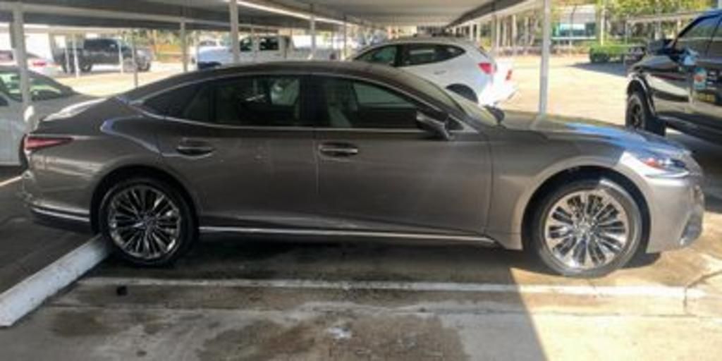 A gray lexus ls 500 is parked in a parking lot.