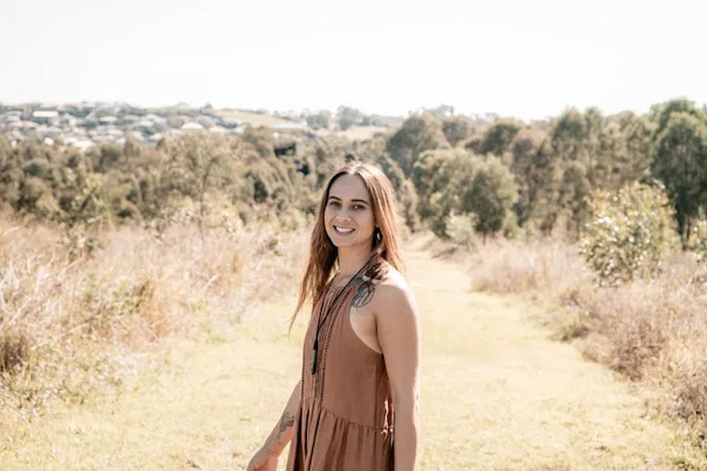 A Woman in a Brown Dress is Standing in a Field — Yoni Steam Australia in Gold Coast, QLD