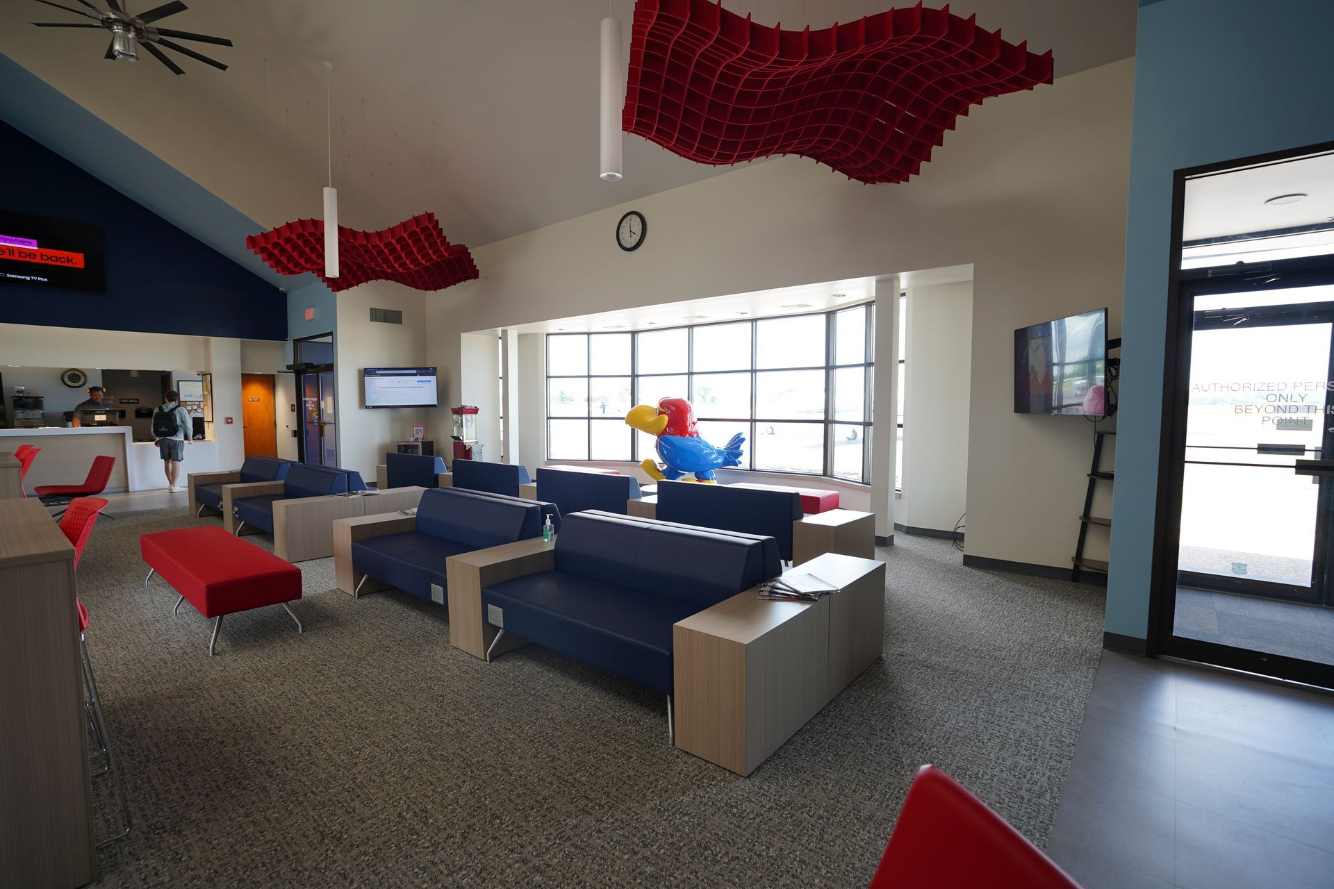 A living room with a lot of couches and chairs