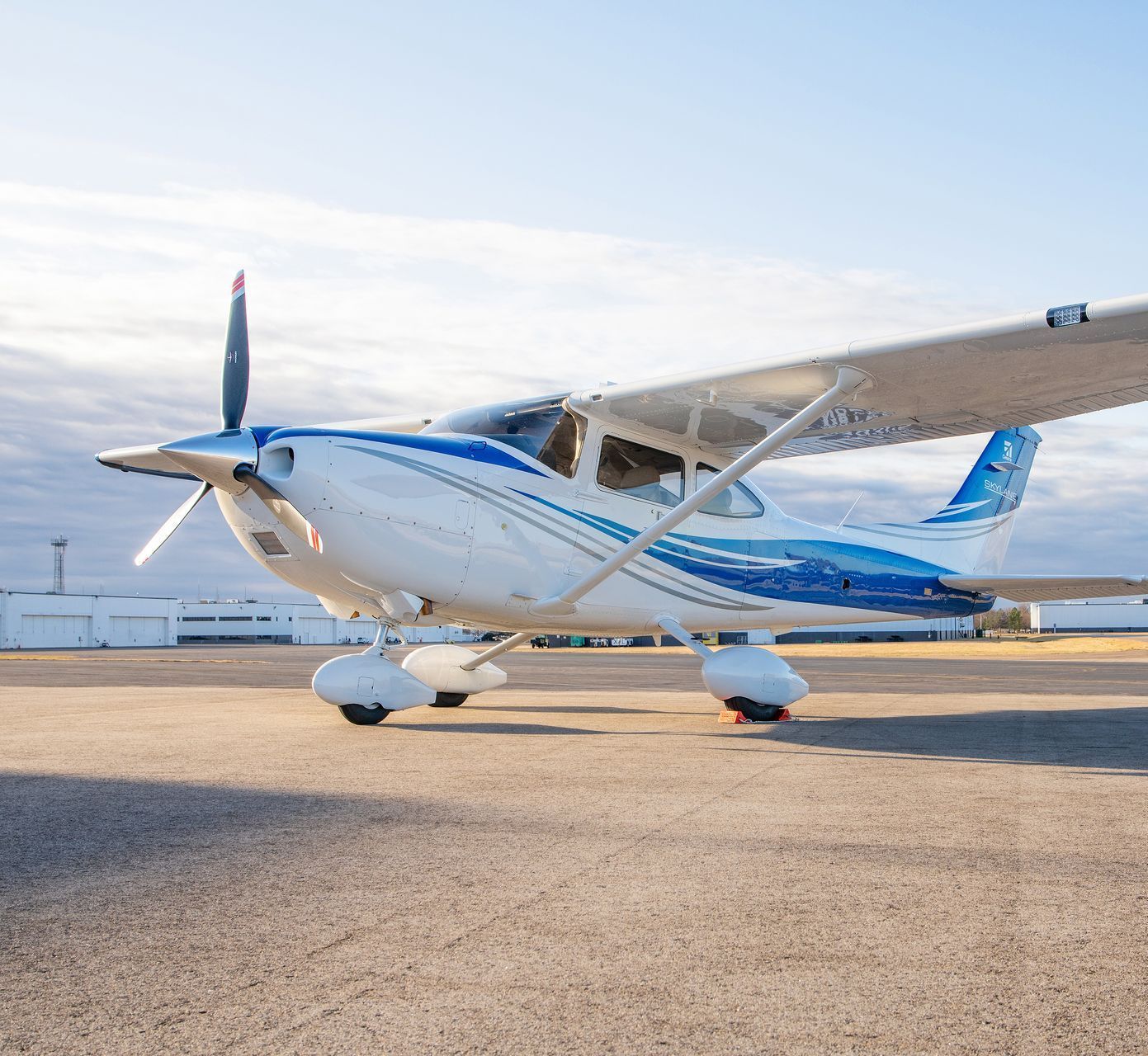 A small propeller plane is parked on a runway.
