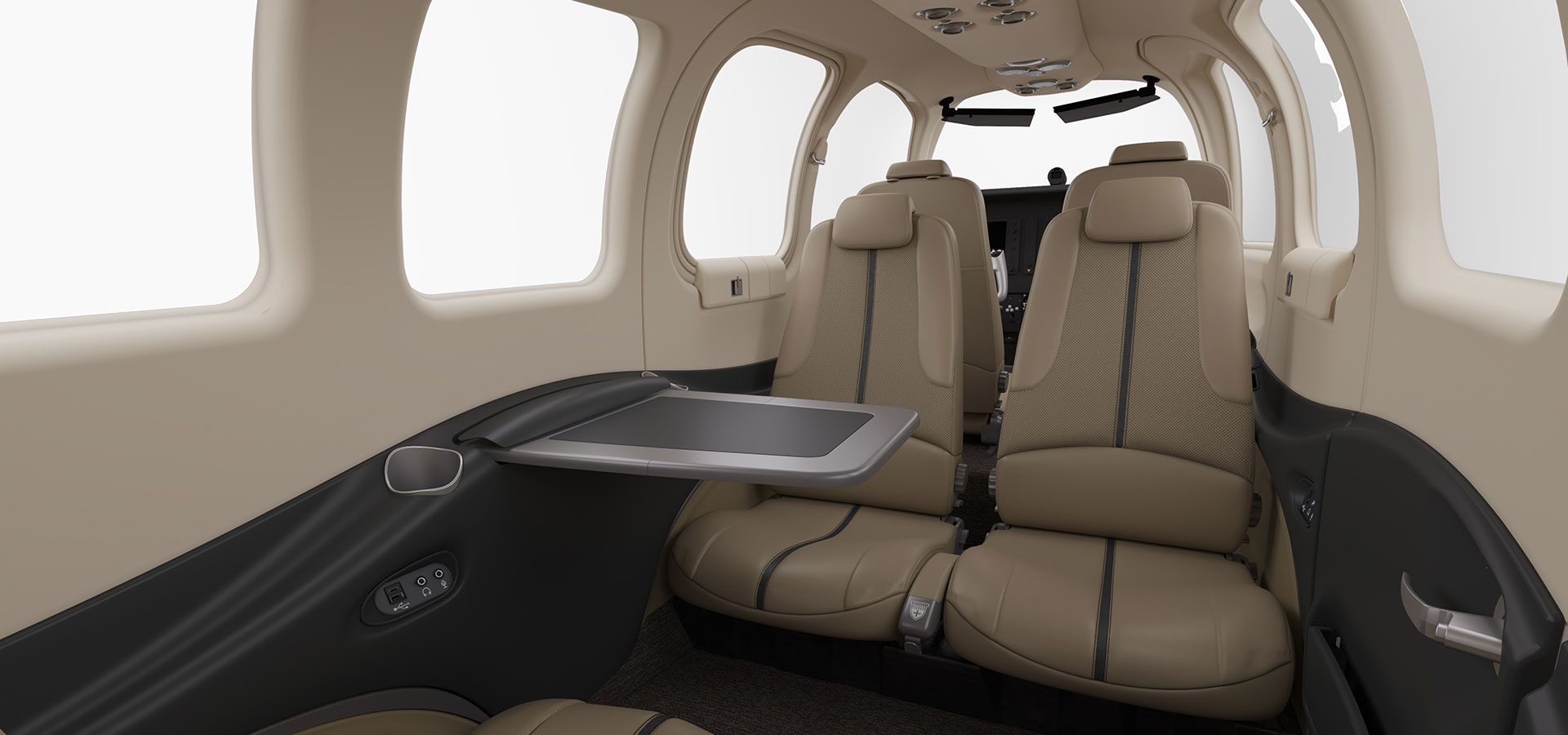 The inside of a private jet with brown leather seats and a cockpit.